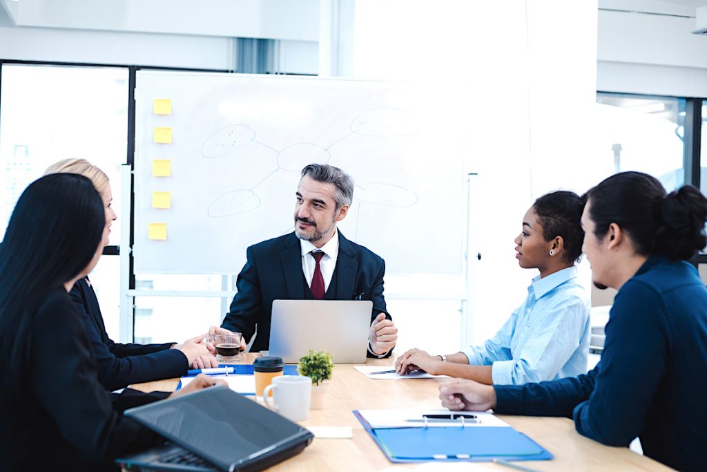 Meeting of corporate business team and manager in meeting room. Meeting discussion of corporate concept. Business people discussing together in conference room during meeting at office.